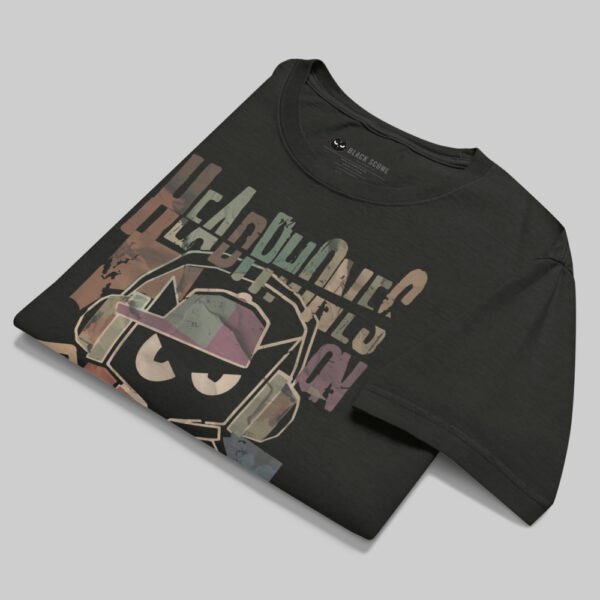 Professional flat-lay shot of a folded Black Scowl black oversized graphic t-shirt showing the interior branding and high-quality 220g cotton texture.