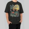 A man wearing a Black Scowl premium 220g oversized black t-shirt with a distressed 'Emotionally Unavailable' cat graphic and vintage typography.