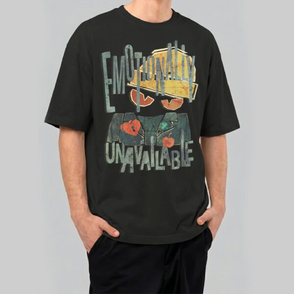 A man wearing a Black Scowl premium 220g oversized black t-shirt with a distressed 'Emotionally Unavailable' cat graphic and vintage typography.