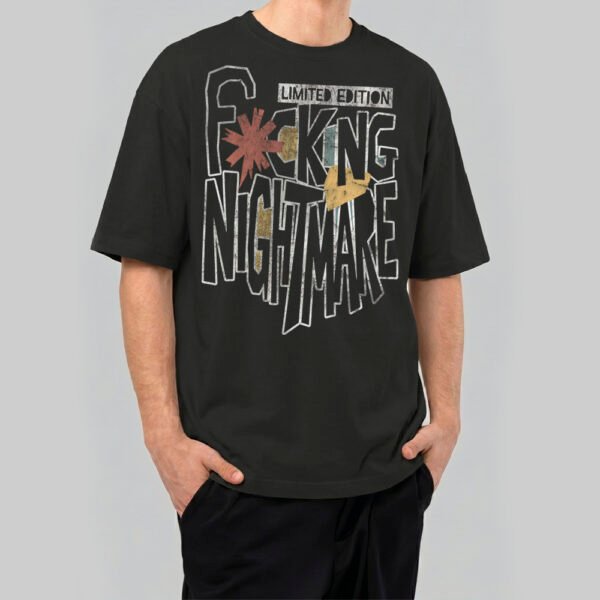 Man wearing a Black Scowl limited edition 220g heavyweight oversized black t-shirt featuring a bold 'Fucking Nightmare' distressed typographic design.