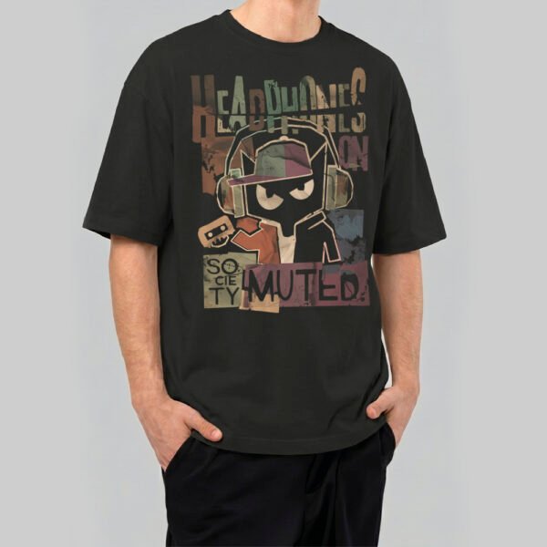 Man wearing a Black Scowl premium 220g oversized black t-shirt with a cynical cat wearing headphones and 'Headphones On Society Muted' text.