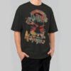 Model wearing a Black Scowl 220g heavyweight oversized black t-shirt featuring a distressed cat graphic with 'Running on Nothing' text in a vintage aesthetic.