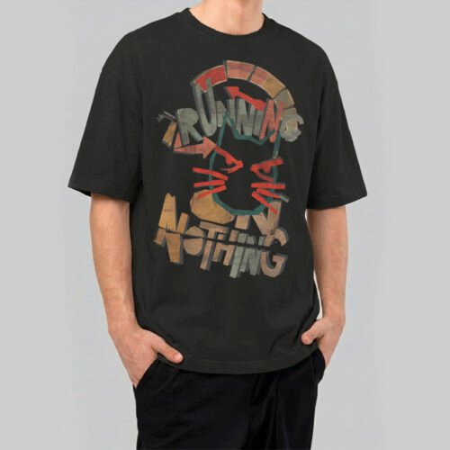 Model wearing a Black Scowl 220g heavyweight oversized black t-shirt featuring a distressed cat graphic with 'Running on Nothing' text in a vintage aesthetic.