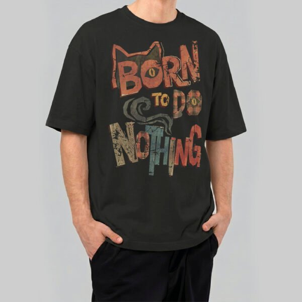 Full view of a model wearing Black Scowl's 220g oversized black t-shirt with a sarcastic cat design and 'Zero Energy Full Attitude' vintage typography.